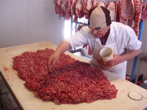mixing the salami meat with vino, salt, pepper, and minimal spices